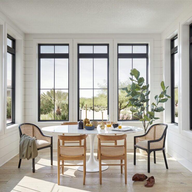 Naturally light dining area with Pella Impervia windows on every wall