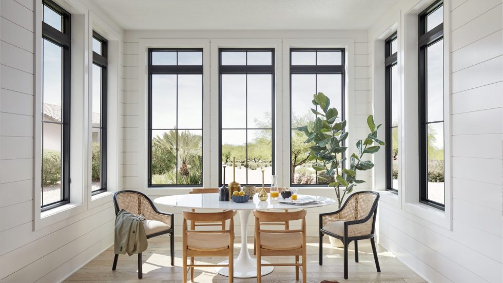 Naturally light dining area with Pella Impervia windows on every wall