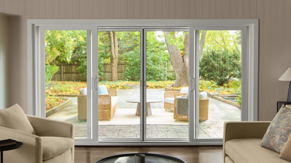 Bright, inviting living space with large sliding glass doors opening to a cozy, green backyard.