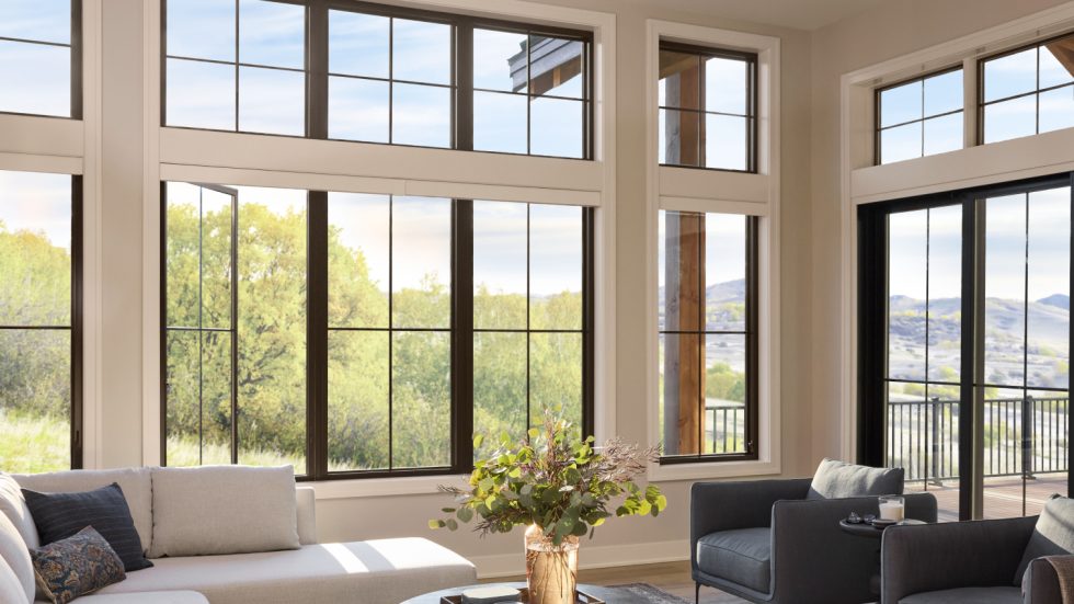 Bright living room with large windows and comfortable seating overlooking peaceful nature views