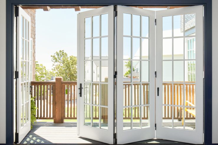 Bright and inviting bifold doors open to a sunny porch with neighborhood views.