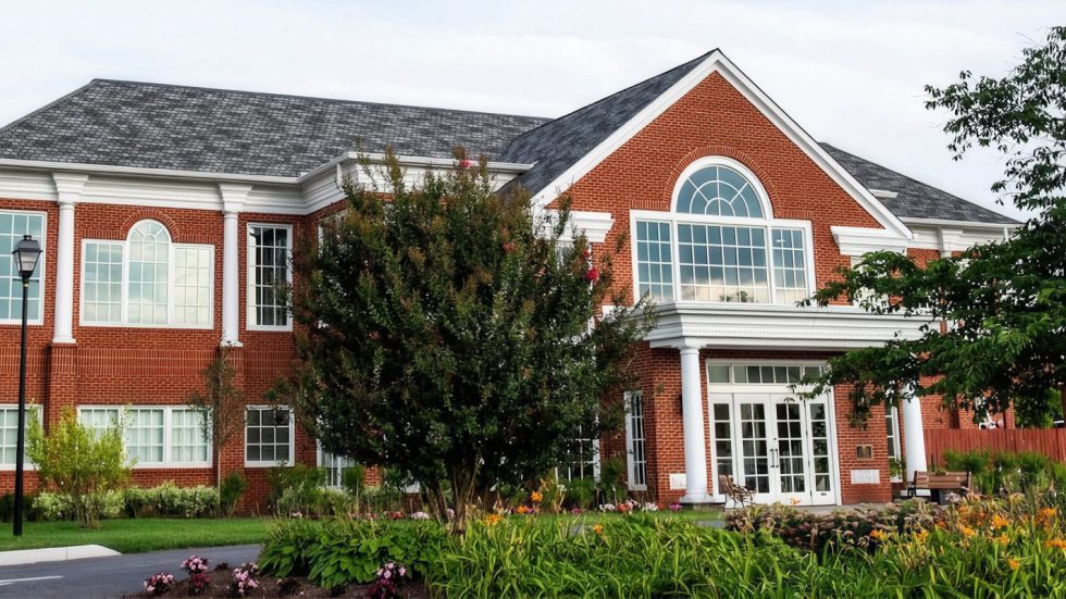 Classic red brick building with Pella Reserve windows invites warmth and community connection.