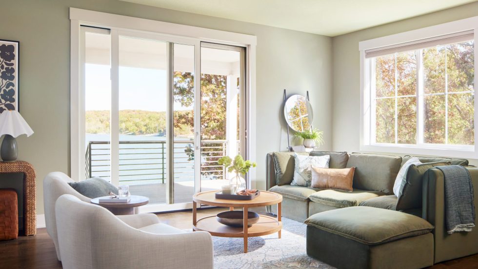 Bright, inviting living room with large patio doors showcasing a peaceful lake view.