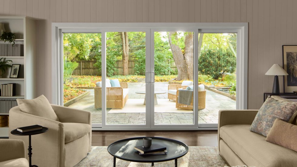 Cozy living room with large sliding glass doors opening to a welcoming outdoor seating area.