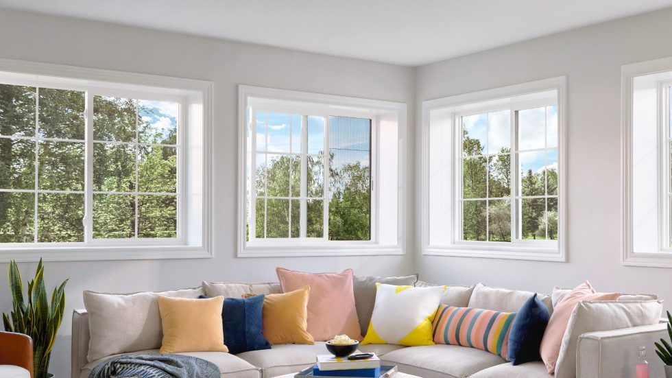Bright, inviting living room with large sliding windows showcasing a lush, green view.